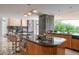 Gourmet kitchen features black countertops, wood cabinets, and sleek stainless steel appliances at 4550 E Foothill Dr, Paradise Valley, AZ 85253