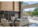 Open concept living room featuring an accent wall and sliding glass doors to the backyard at 4550 E Foothill Dr, Paradise Valley, AZ 85253