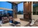 Inviting living room featuring large windows, a stone fireplace, and comfortable seating at 4550 E Foothill Dr, Paradise Valley, AZ 85253