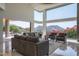 Open living room with floor-to-ceiling windows offering mountain views and access to the backyard at 4550 E Foothill Dr, Paradise Valley, AZ 85253