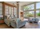 Serene main bedroom with natural light, a cozy seating area, and seamless access to a private terrace at 4550 E Foothill Dr, Paradise Valley, AZ 85253