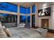 Spacious main bedroom featuring a fireplace, floor-to-ceiling windows, and comfortable seating at 4550 E Foothill Dr, Paradise Valley, AZ 85253