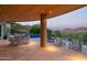 Expansive outdoor patio with dining and lounge seating, a fire pit, mountain views, and covered ceiling at 4550 E Foothill Dr, Paradise Valley, AZ 85253