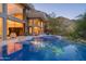 Stunning infinity pool reflecting modern home, surrounded by desert landscape with mountain views at 4550 E Foothill Dr, Paradise Valley, AZ 85253