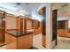 Large walk-in closet with custom shelving, cabinets, central island, and decorative lighting at 4550 E Foothill Dr, Paradise Valley, AZ 85253