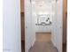 Hallway view of a clean and bright bathroom with double vanities, and a large mirror at 4630 S 23Rd Pl, Phoenix, AZ 85040
