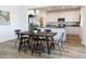 Open-concept dining area with wood flooring, table and chairs, and a view of the kitchen at 4630 S 23Rd Pl, Phoenix, AZ 85040