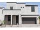Inviting two-story home with a white stucco, dark roof, brown garage door and paved driveway at 4630 S 23Rd Pl, Phoenix, AZ 85040