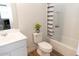 Well-maintained bathroom features a bathtub with a shower, white vanity and floral arrangement at 4634 S 23Rd Pl, Phoenix, AZ 85040
