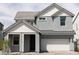 Two-story home featuring gray accents, light gray stucco, a front-entry garage, and a manicured lawn at 4634 S 23Rd Pl, Phoenix, AZ 85040
