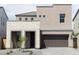 Two-story home featuring tan and brick accents, a front-entry garage, and desert landscaping at 4634 S 23Rd Pl, Phoenix, AZ 85040