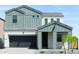 Charming two-story home with gray accents, a dark garage door, and well-kept landscaping at 4634 S 23Rd Pl, Phoenix, AZ 85040