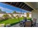 Relaxing backyard with manicured lawn, garden area, and patio seating at 4846 E Piccadilly Rd, Phoenix, AZ 85018