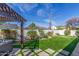 Lush backyard with artificial turf, putting green, and ample space for outdoor activities at 4846 E Piccadilly Rd, Phoenix, AZ 85018