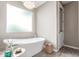 Relaxing bathroom with a standalone tub, natural light, and modern fixtures at 4846 E Piccadilly Rd, Phoenix, AZ 85018