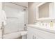 Bright bathroom with a shower over tub, white vanity, and modern fixtures at 4846 E Piccadilly Rd, Phoenix, AZ 85018