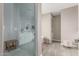 Elegant bathroom showcasing a glass-enclosed shower, a bench, and a gray color palette at 4846 E Piccadilly Rd, Phoenix, AZ 85018