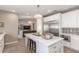 Modern kitchen with white cabinets, quartz countertops, stainless steel appliances, and eat-in island at 4846 E Piccadilly Rd, Phoenix, AZ 85018