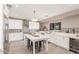 Bright kitchen with white cabinets, large island, designer tile backsplash, and stainless steel appliances at 4846 E Piccadilly Rd, Phoenix, AZ 85018