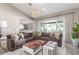 Inviting living room flows to kitchen, with a large sofa, stylish decor, and bright natural light at 4846 E Piccadilly Rd, Phoenix, AZ 85018
