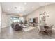Spacious living room featuring vaulted ceilings, neutral tones, modern furniture, and sliding glass doors to the outside at 4846 E Piccadilly Rd, Phoenix, AZ 85018