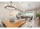 Open-concept living and dining area, featuring hardwood floors, vaulted ceilings, and modern décor at 4846 E Piccadilly Rd, Phoenix, AZ 85018