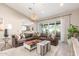Comfortable living room with large sofa, stylish decor, and seamless flow to kitchen through the large window at 4846 E Piccadilly Rd, Phoenix, AZ 85018
