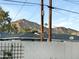 Neighborhood view with mountain backdrop, complemented by secure block fencing and clear blue sky at 4846 E Piccadilly Rd, Phoenix, AZ 85018