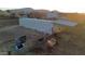 Horse on equestrian property with loading containers and stalls, ideal for trainers or horse enthusiasts at 50702 W Hector Rd, Aguila, AZ 85320