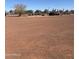 Extensive riding arena space, bordered by fencing, vegetation, and additional amenities at 50702 W Hector Rd, Aguila, AZ 85320