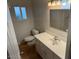 Bright bathroom featuring a vanity with a single sink, toilet, and window at 5201 W Camelback Rd # 181, Phoenix, AZ 85031