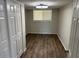 Bedroom with plank flooring, closet with doors, neutral walls and a bright window at 5201 W Camelback Rd # 181, Phoenix, AZ 85031