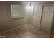 Bedroom with tiled floors, closet with sliding doors, and plenty of natural light at 5201 W Camelback Rd # 181, Phoenix, AZ 85031
