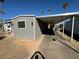 Manufactured home featuring an expansive covered parking area perfect for vehicles or outdoor entertaining at 5201 W Camelback Rd # 181, Phoenix, AZ 85031