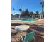 View of the community pool area with comfortable seating and lush landscaping at 5201 W Camelback Rd # A7, Phoenix, AZ 85031