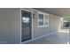 Front entrance with a gray wall and a decorated front door, creating a welcoming entry at 5201 W Camelback Rd # A7, Phoenix, AZ 85031