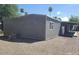 View of home with gray exterior, showcasing the well-maintained gravel landscaping at 5201 W Camelback Rd # A7, Phoenix, AZ 85031