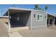 Charming gray home with a covered carport offers shade and protection from the elements at 5201 W Camelback Rd # A7, Phoenix, AZ 85031