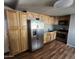 Bright kitchen features stainless steel appliances, wooden cabinets, and wood floors at 5201 W Camelback Rd # A7, Phoenix, AZ 85031