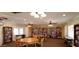 Library with large bookcases and multiple tables that offers a quiet space for residents at 5201 W Camelback Rd # A7, Phoenix, AZ 85031