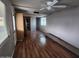 Spacious living room with lots of light and wood floors looking into the kitchen at 5201 W Camelback Rd # A7, Phoenix, AZ 85031