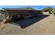 Backyard view featuring a screened-in porch area, landscaping, and gravel ground cover at 523 S Park View Cir, Mesa, AZ 85208