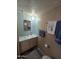 Cozy bathroom features a vanity with a white sink, decorative mirror, and blue towels at 523 S Park View Cir, Mesa, AZ 85208
