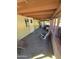 Relaxing covered porch with comfortable seating, carpeted floors, and brick accents at 523 S Park View Cir, Mesa, AZ 85208