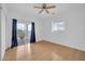 Bright bedroom with a ceiling fan, light wood floors, and sliding glass doors to a balcony at 5338 N 21St Ave, Phoenix, AZ 85015