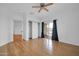 Open bedroom featuring wood floors, a ceiling fan, and access to the outdoor balcony at 5338 N 21St Ave, Phoenix, AZ 85015