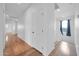 Upstairs hallway with hardwood floors, white trim, and natural light at 5338 N 21St Ave, Phoenix, AZ 85015