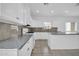 Well-lit kitchen with white cabinetry, granite countertops, and tile flooring at 5338 N 21St Ave, Phoenix, AZ 85015