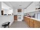 Open kitchen with white upper cabinets, wooden lower cabinets, and tile flooring at 5338 N 21St Ave, Phoenix, AZ 85015