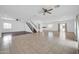 Spacious living area with tile flooring, ceiling fans, and a staircase at 5338 N 21St Ave, Phoenix, AZ 85015